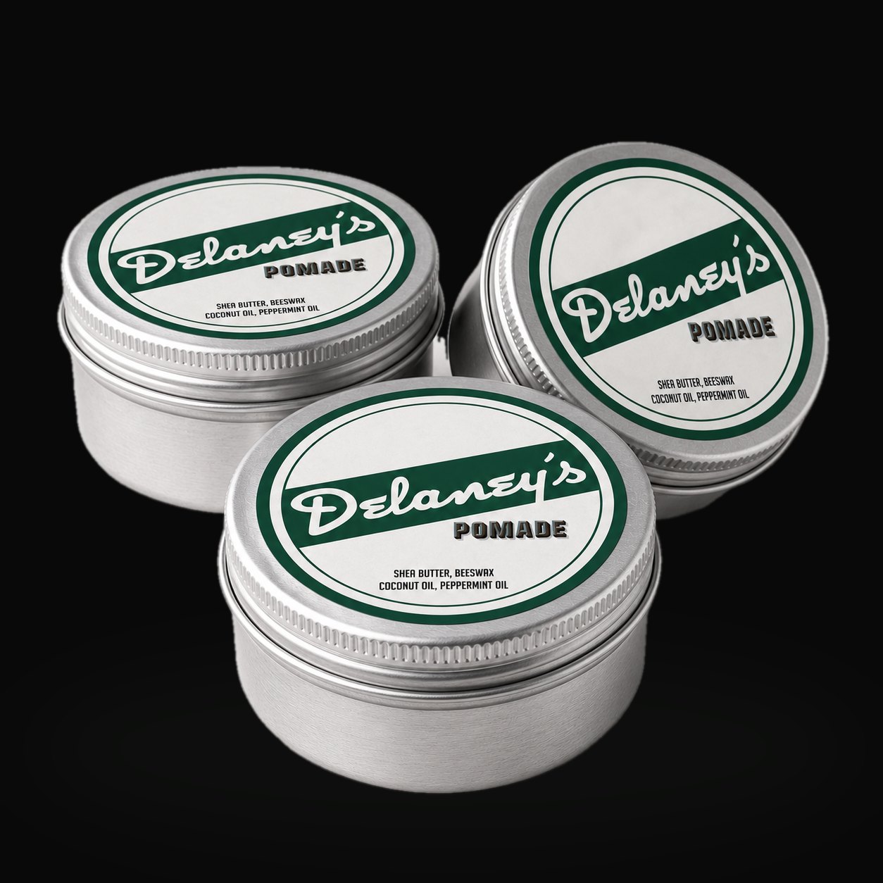 Three tins of Delaney's Pomade